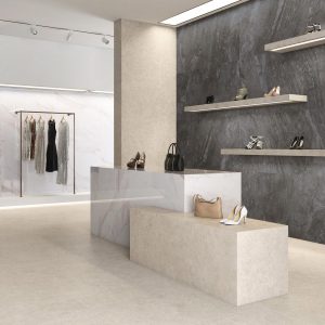 Moleanos - Winkel en showroom met witte en zwarte steenlook op vloer en wand en balie, Pamesa