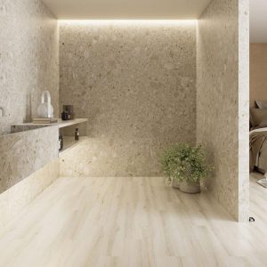 Pietra Di Gre - wellnessBadkamer met gespikkelde steenwanden en bleke hout- of steenlook vloer, Pamesa